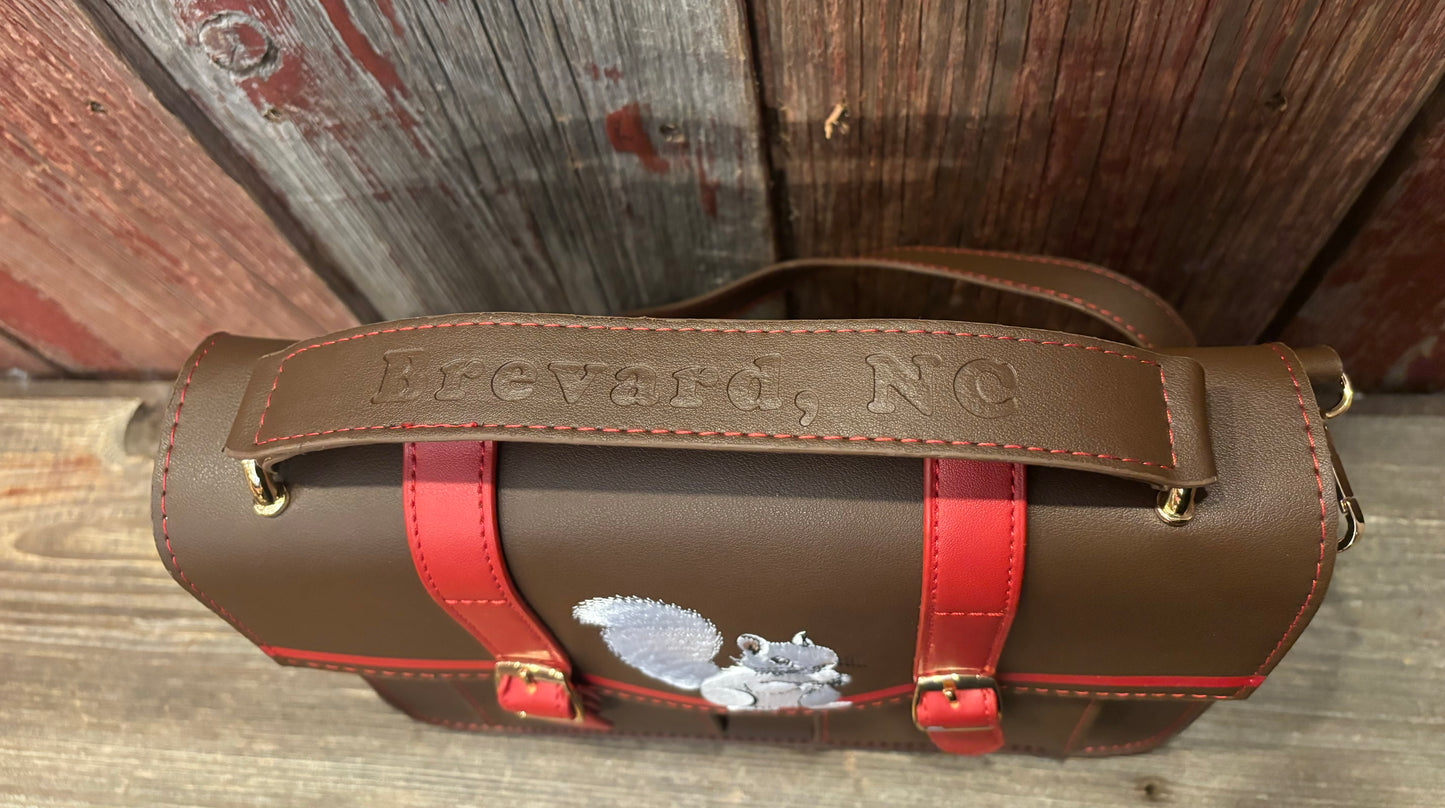 Messenger bag handle showing Brevard NC imprint and white squirrel design