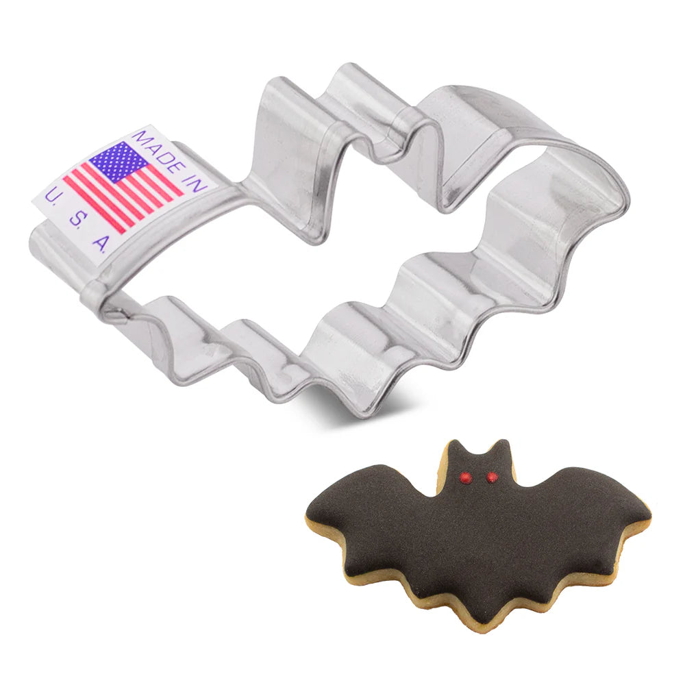 Bat-shaped cookie cutter with a made in USA label next to a bat-shaped cookie