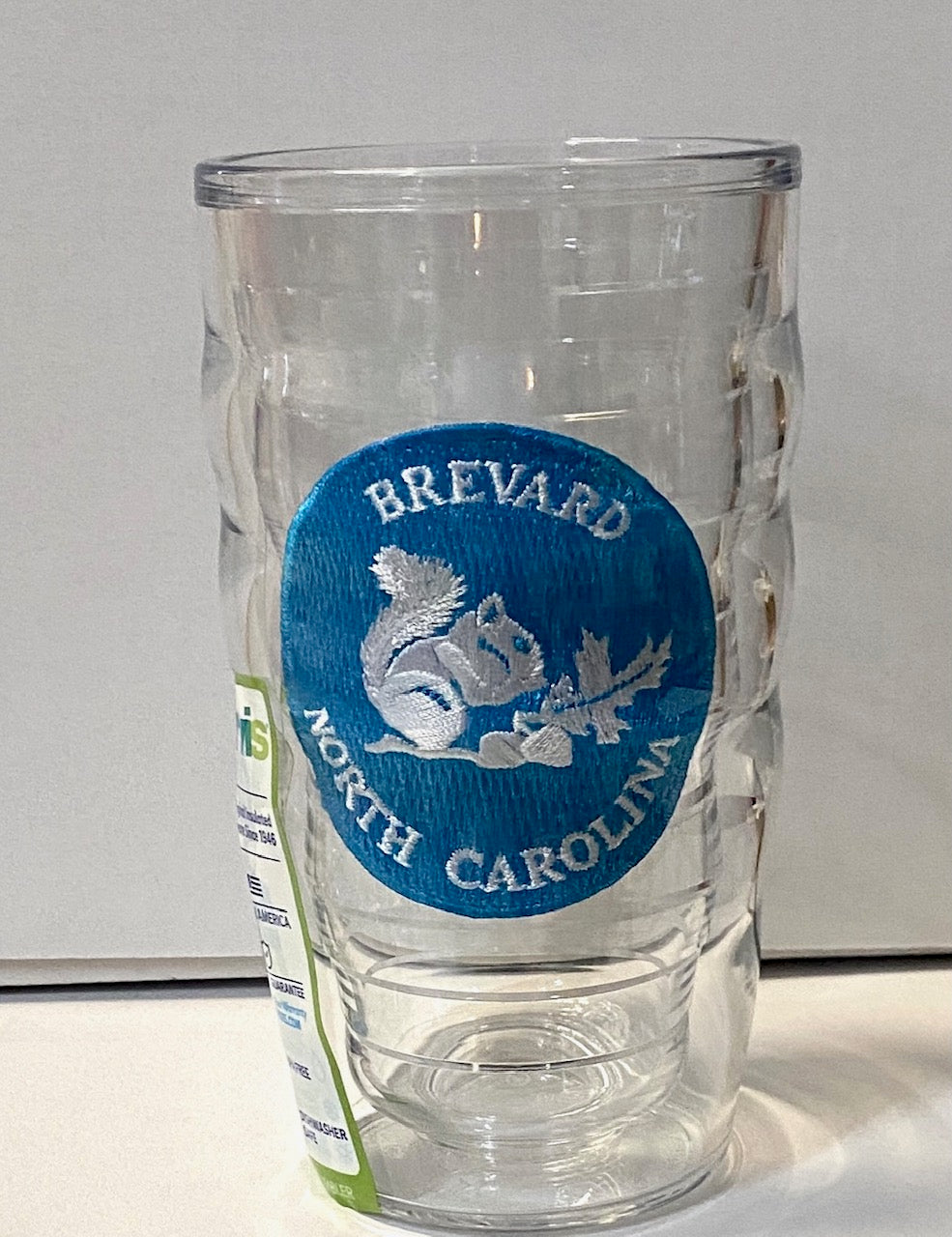 A clear plastic 10 oz. Tervis tumbler with a wavy design and a blue logo 'BREVARD NORTH CAROLINA' on the front.