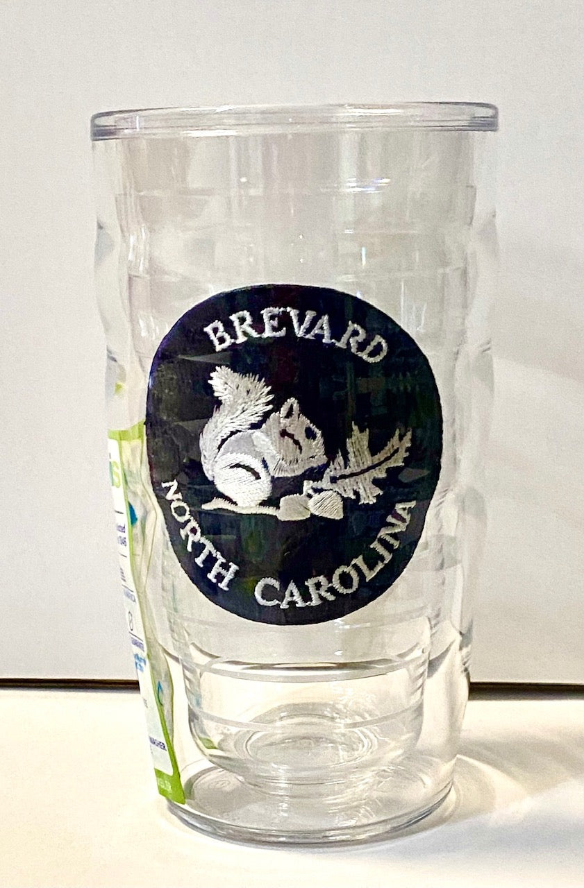 A clear plastic 10 oz. Tervis tumbler with a wavy design and a navy blue logo 'BREVARD NORTH CAROLINA' on the front.