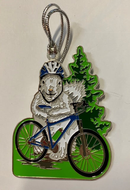 This two-sided metal ornament features a white squirrel in his blue and white helmet about to hop on his bicycle.