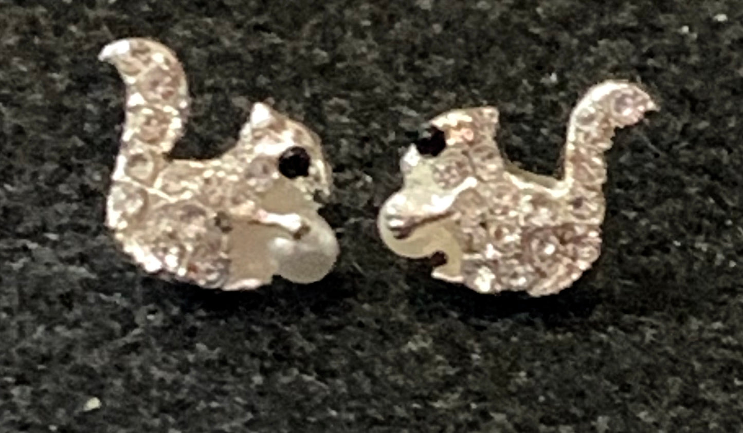 Up close image of our white squirrel rhinestone stud earrings. Our squirrel is holding a pearl - his 'acorn'.