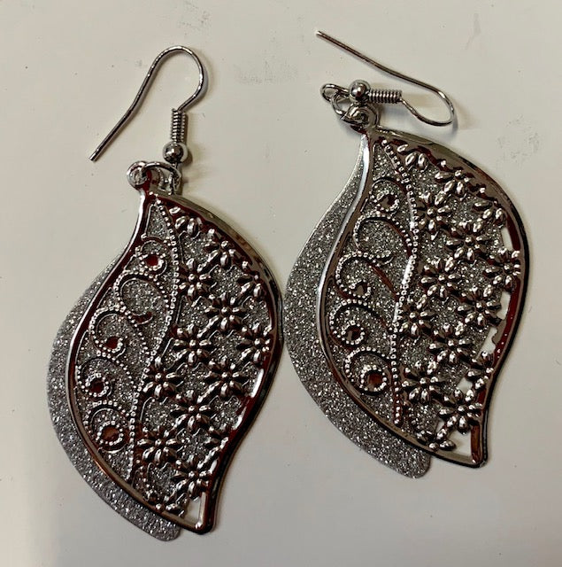 Silver metal earrings in the shape of a paisley