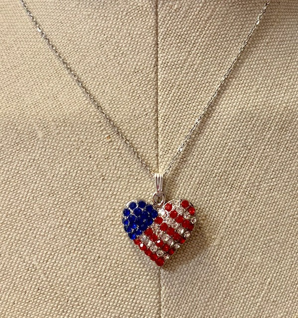 Patriotic crystal heart pendant with an American Flag design with crystals. Includes 18" chain.