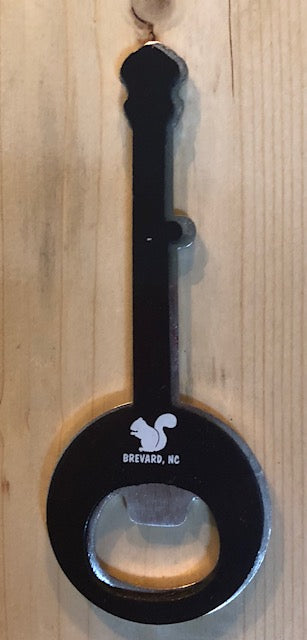 Magnetic bottle opener in the shape of a banjo with a white squirrel and 'Brevard, NC' on back.