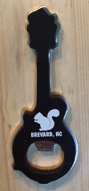 Magnetic bottle opener in the shape of a mandolin includes a white squirrel profile and the words 'Brevard, NC' on the back.
