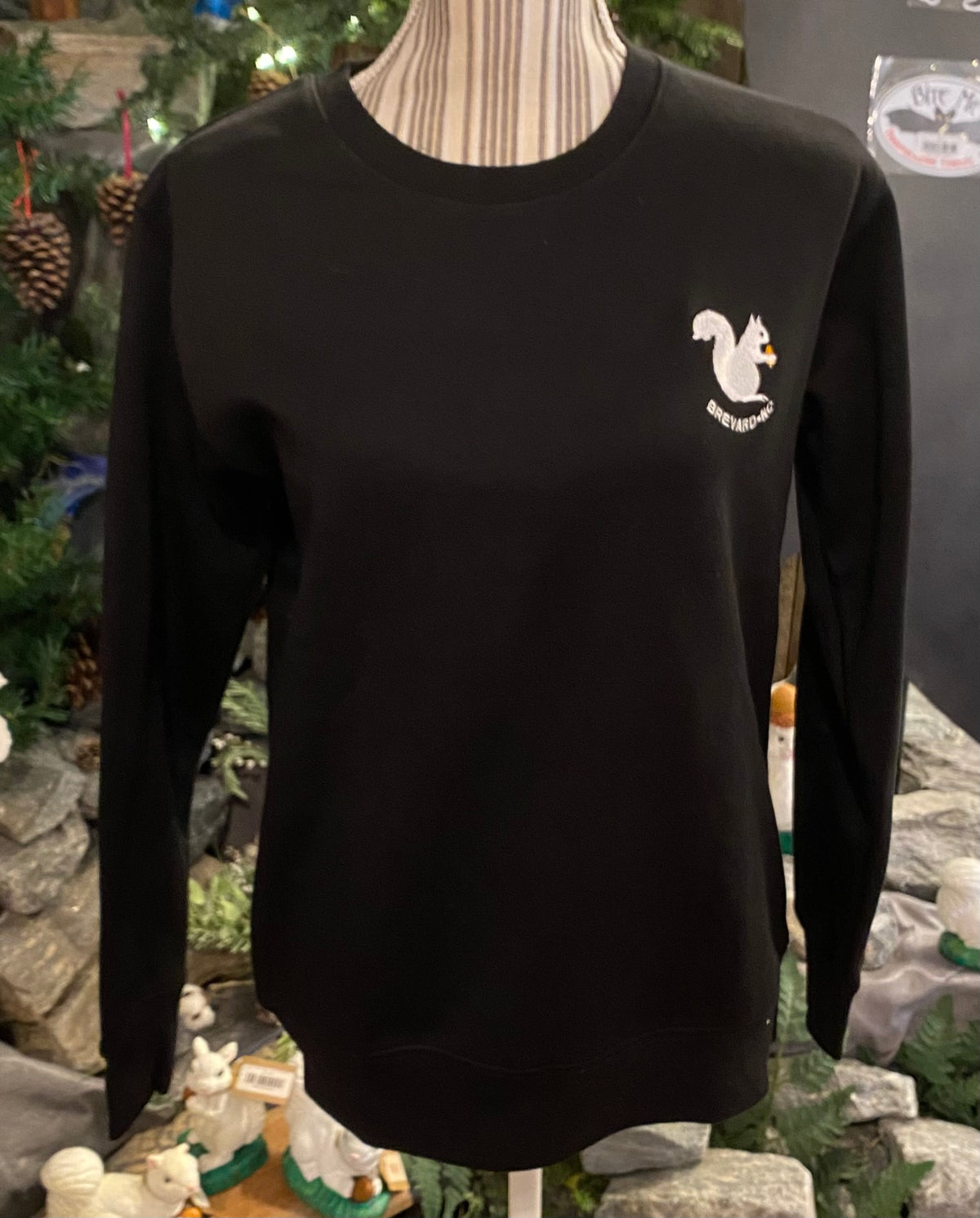 A long sleeve black crew neck sweatshirt with an embroidered white squirrel logo and Brevard, NC on the front.