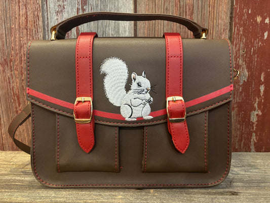 White Squirrel embroidered messenger bag from Brevard NC with handle up close.