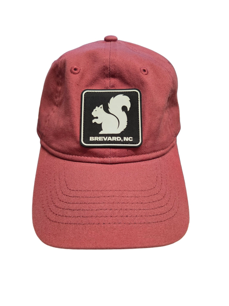 Red cap with a squirrel logo and 'Brevard, NC' text on a white background