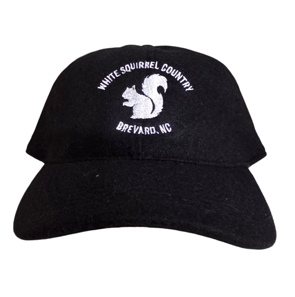 Black cap with white squirrel logo and 'White Squirrel Country Brevard, NC'.