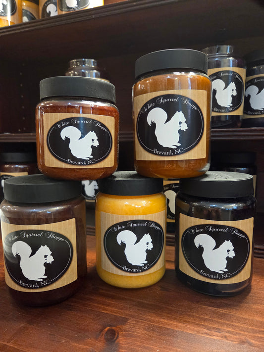 Southern comfort scented candles in 16 oz and 26 oz glass jars with White Squirrel Shoppe labels showing 5 different fragrances