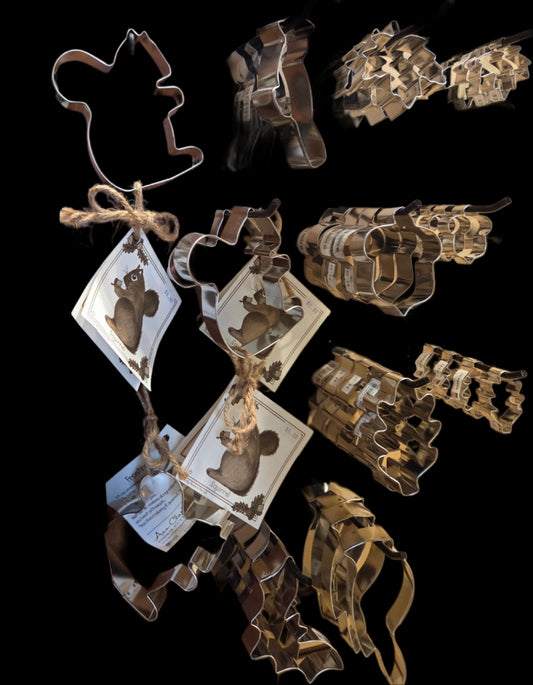 Collection of metal cookie cutters shaped like animals on a black background