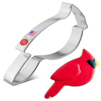 Metallic cookie cutter shaped like a red cardinal bird on a white background