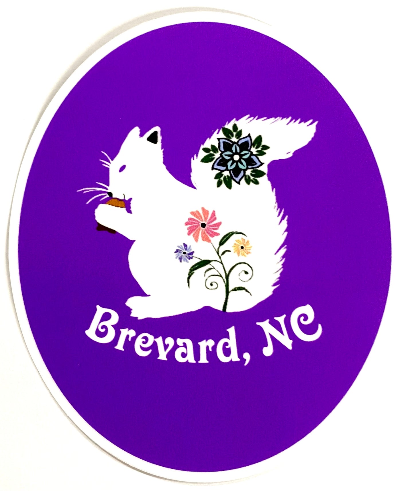A round purple decal with the silhouette of a white squirrel holding a floral tail, and the text 'Brevard, NC' in the center.