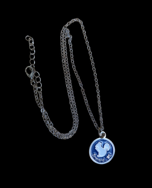 Necklace with a blue pendant on a black background