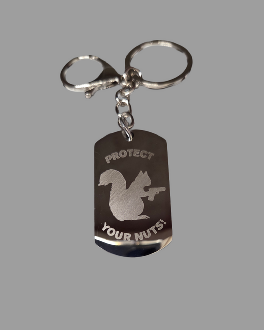 Keychain with a dog tag design featuring a squirrel and text on a gray background