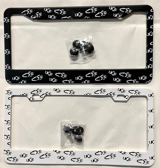 Two aluminum license plate holders with white and black squirrel paw prints design, including mounting hardware.
