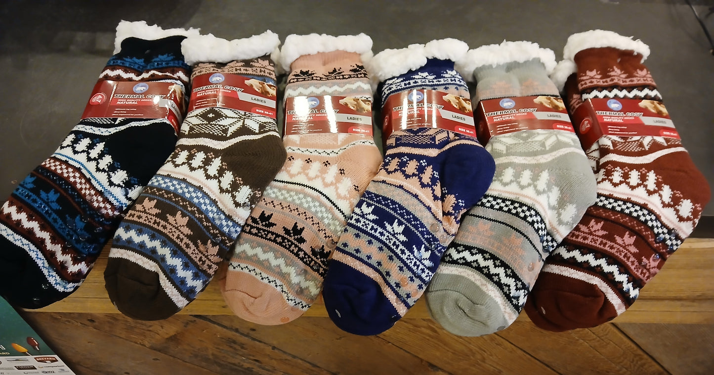 A collection of colorful fleece-lined slipper socks with no-slip bottoms displayed on a surface.