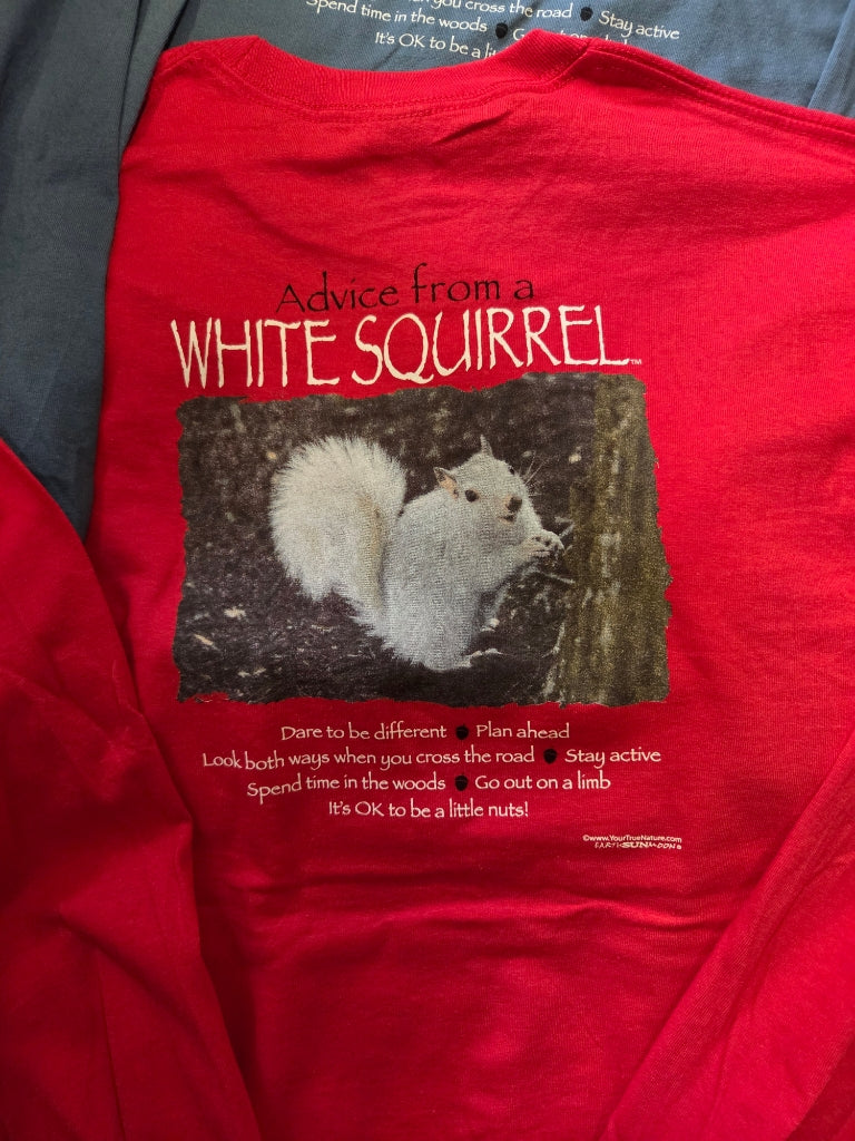 Red t-shirt with a graphic of a white squirrel and humorous text on a hanger.