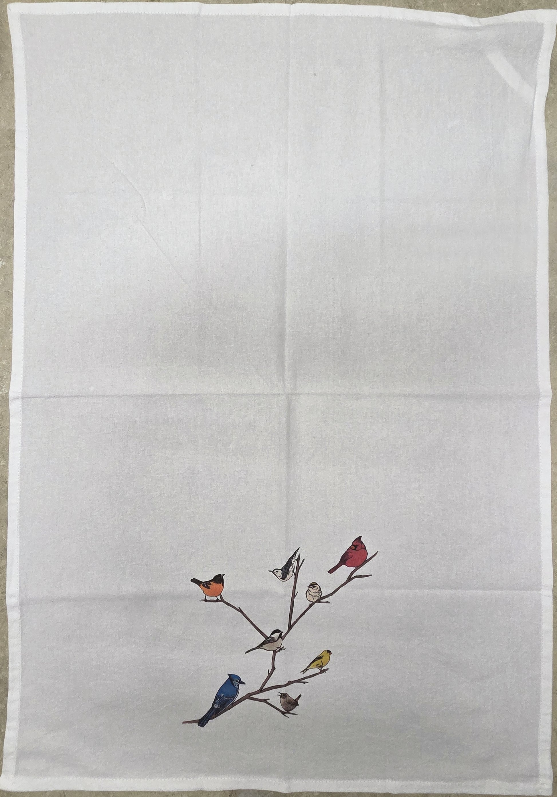 Embroidered design of birds on a branch on a white fabric background