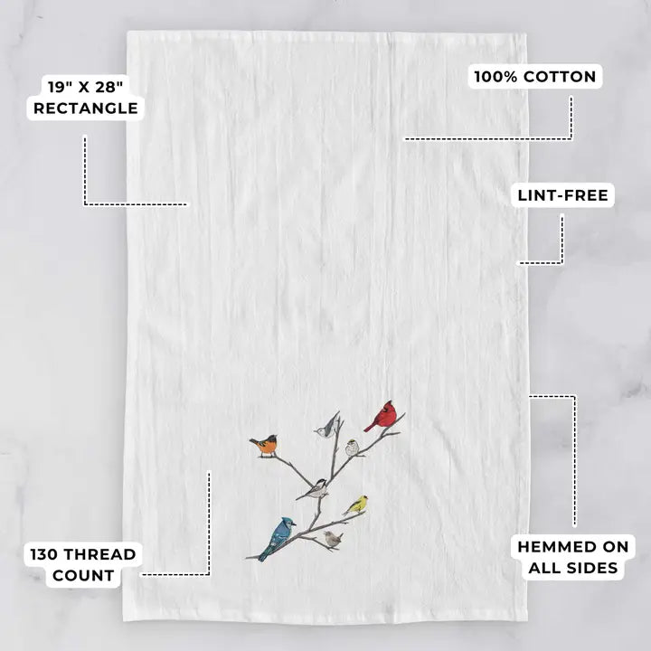 White towel with bird design on a gray background, featuring text about dimensions and material.