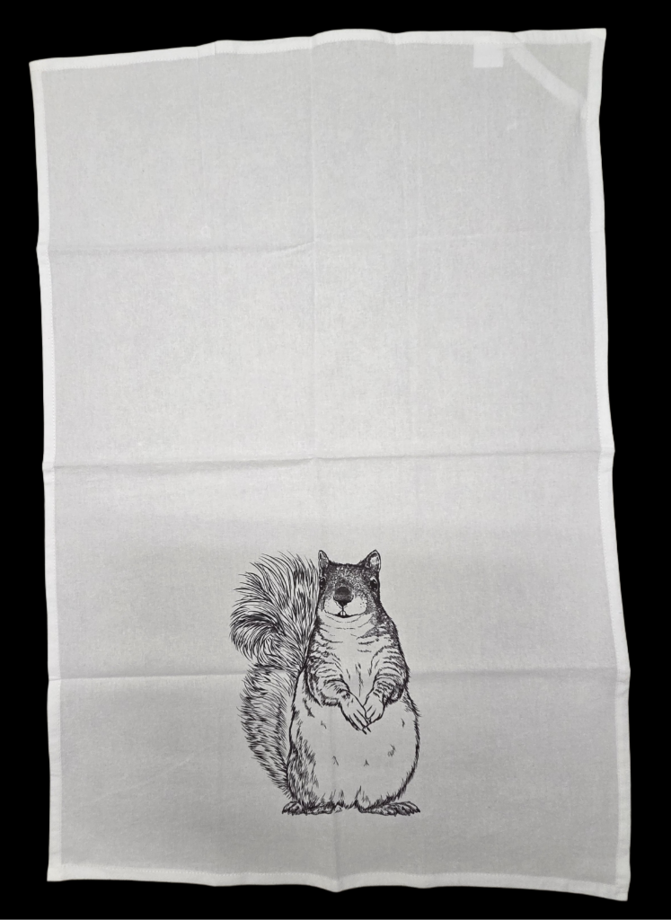 White towel with a black and white illustration of a squirrel on a black background