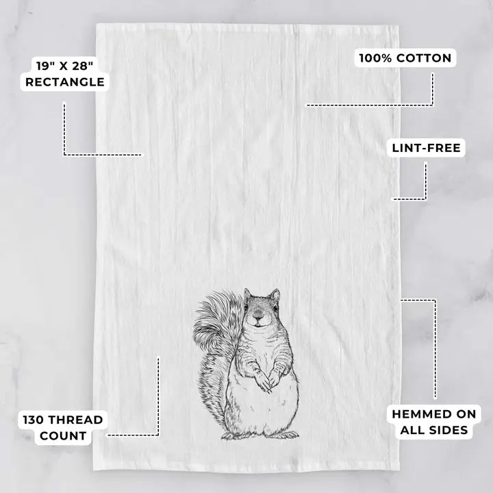 Tea towel with a squirrel design on a light gray background, featuring text about dimensions and material.