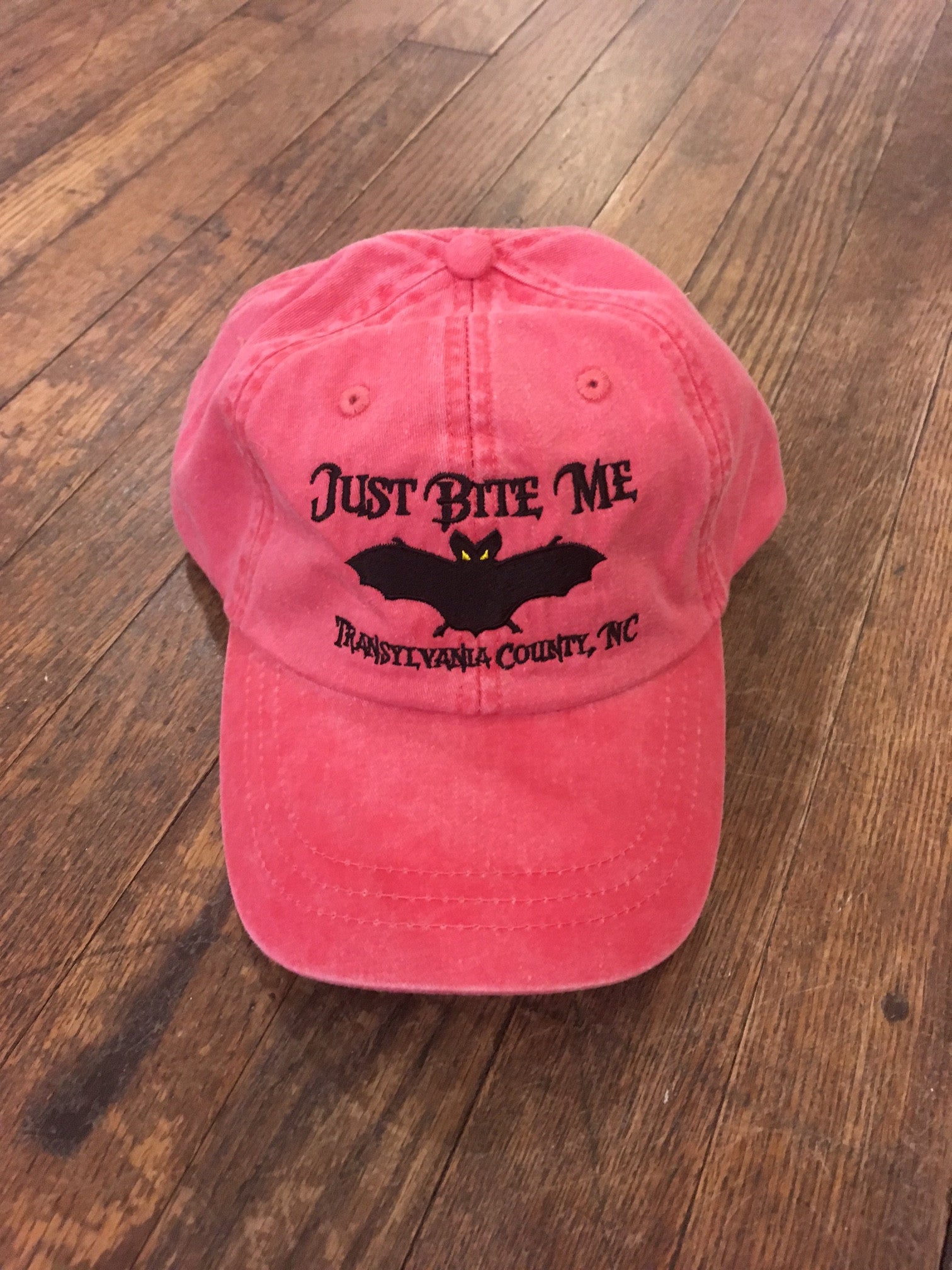 Baseball_Hat_with_Just_Bite_Me_and_Transylvania_County_in_Hot_Pink
