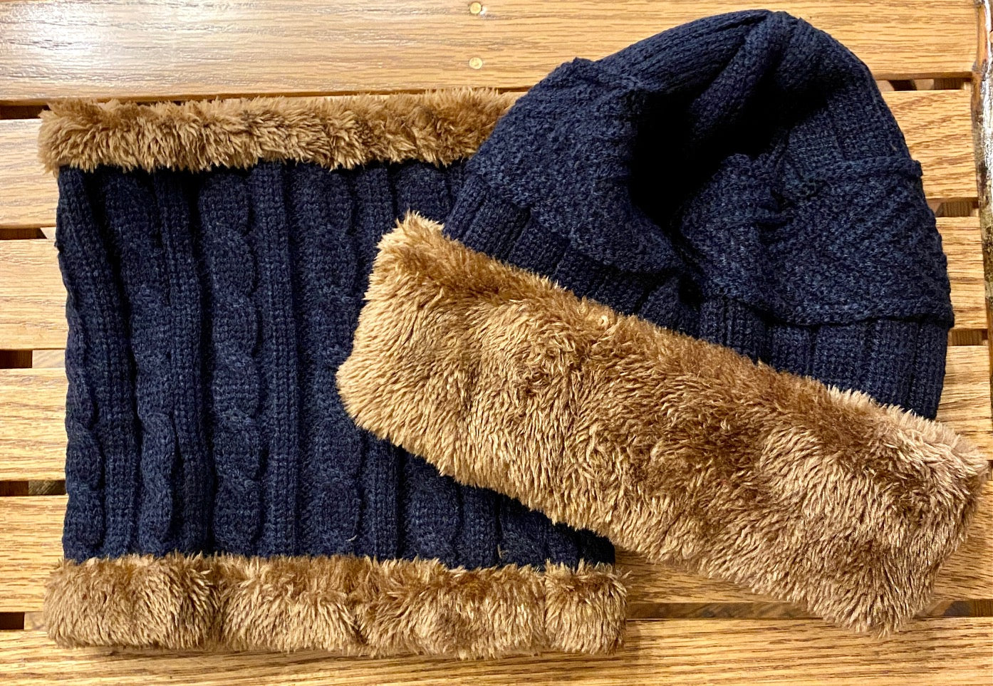 Cable knit beanie and neck warmer with faux fur detail in blue and tan.