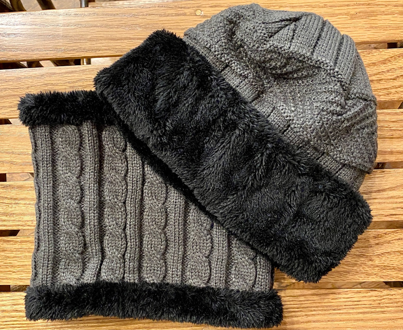Cable knit beanie and neck warmer with fur detail in gray.