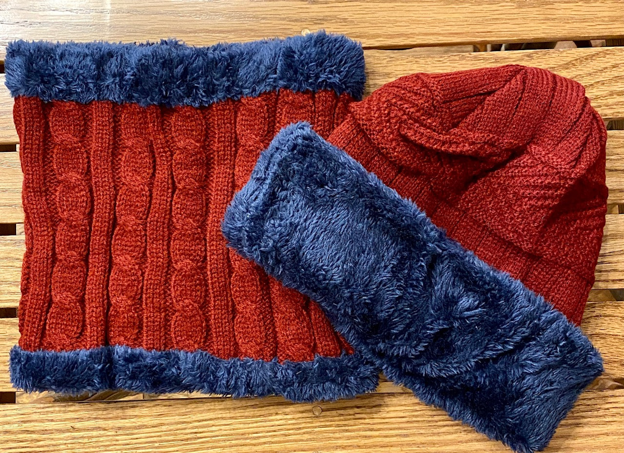 Cable knit beanie and neck warmer with faux fur detail in red and blue.