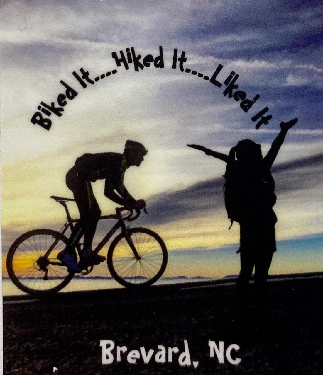 A vinyl decal with an illustration of a person on a bicycle and another person hiking, with text 'Biked It...Hiked It...Liked It'.