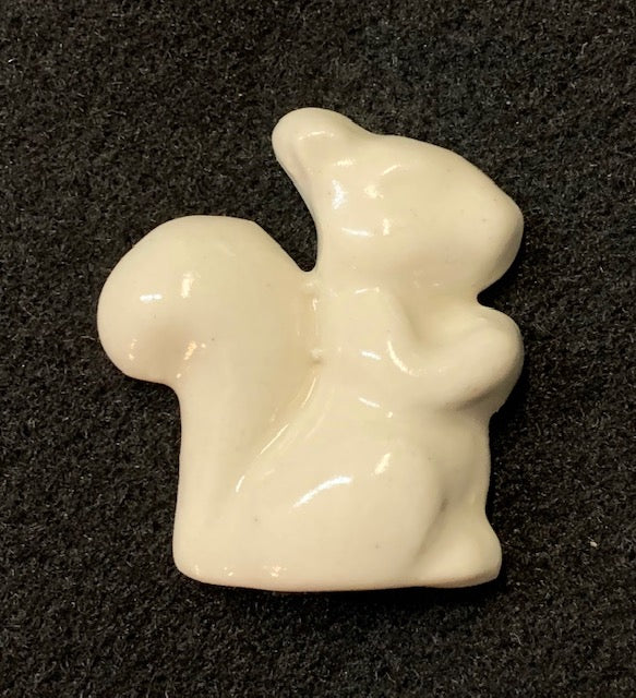 Handcrafted ceramic magnet in the shape of a white squirrel facing right, with a smooth white finish.