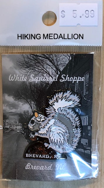 Packaged hiking stick medallion featuring an image of a white squirrel with Brevard, NC imprint.