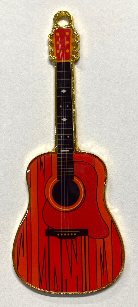 A red metal guitar-shaped ornament with a white squirrel design and the text 'Brevard, NC' on the back.