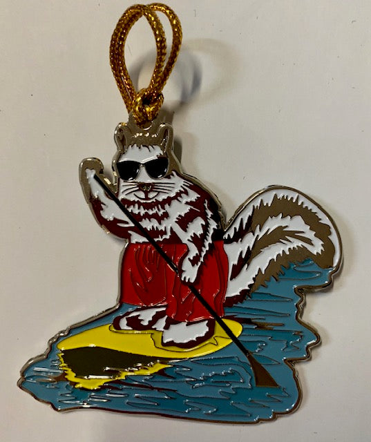 A two-sided metal ornament with a white squirrel paddle boarding.