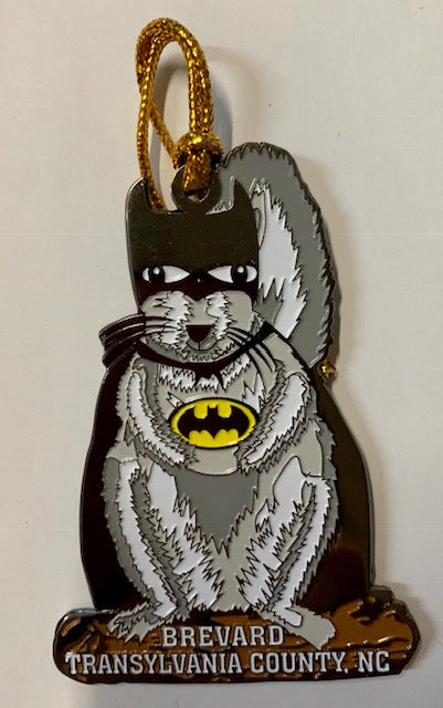 A metal ornament in the shape of a white squirrel wearing a Batman costume.