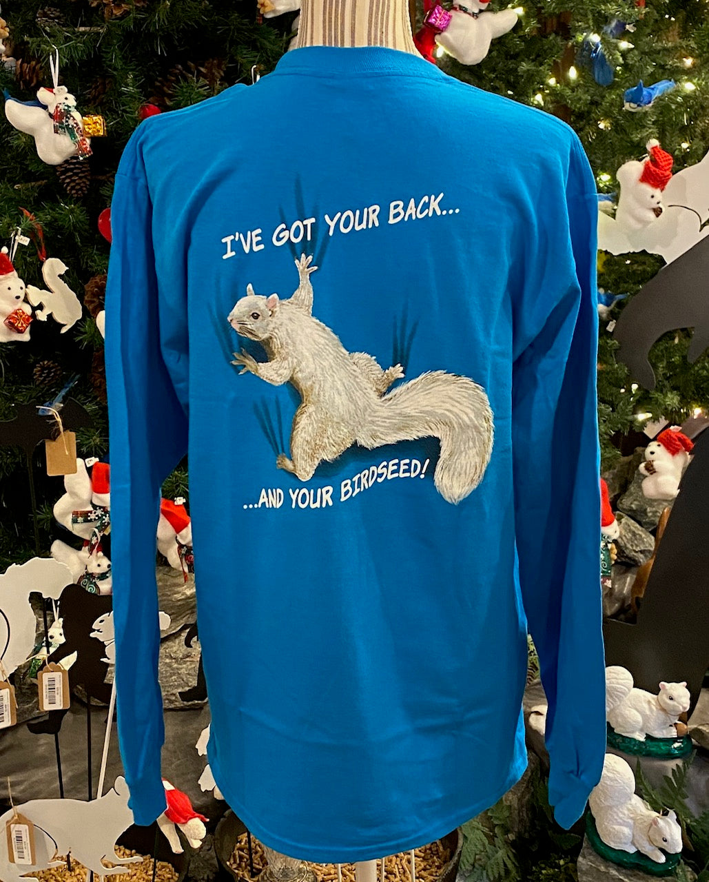A long-sleeve crew neck t-shirt in sapphire blue with a graphic of a squirrel and the text 'I've Got Your Back.