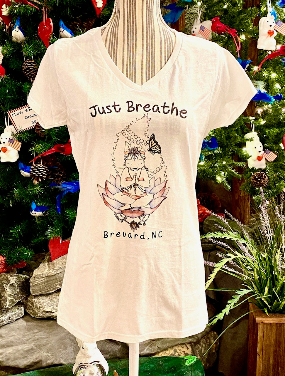 A white short sleeve fitted v-neck t-shirt for ladies with a graphic print of a white squirrel and the text 'Just Breathe Brevard, NC'.