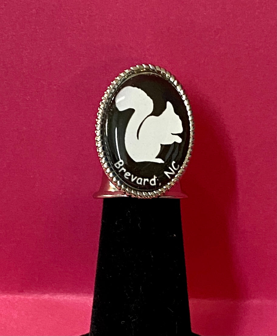 Collectible white squirrel thimble on a display.