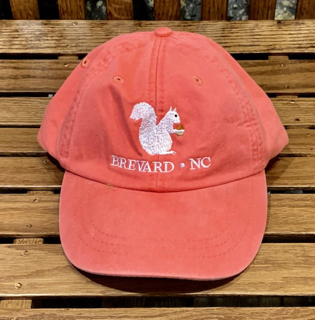 White Squirrel embroidered baseball cap from Brevard NC in coral color