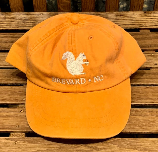 White Squirrel embroidered baseball cap from Brevard NC in tangerine orange color